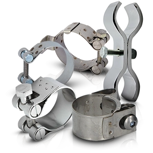 Various silver exhaust clamps and brackets for motorcycles.